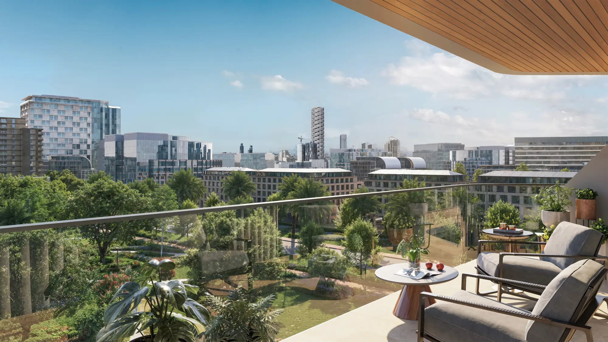 Balcony with outdoor seating overlooking a modern city skyline and green park under a clear blue sky.