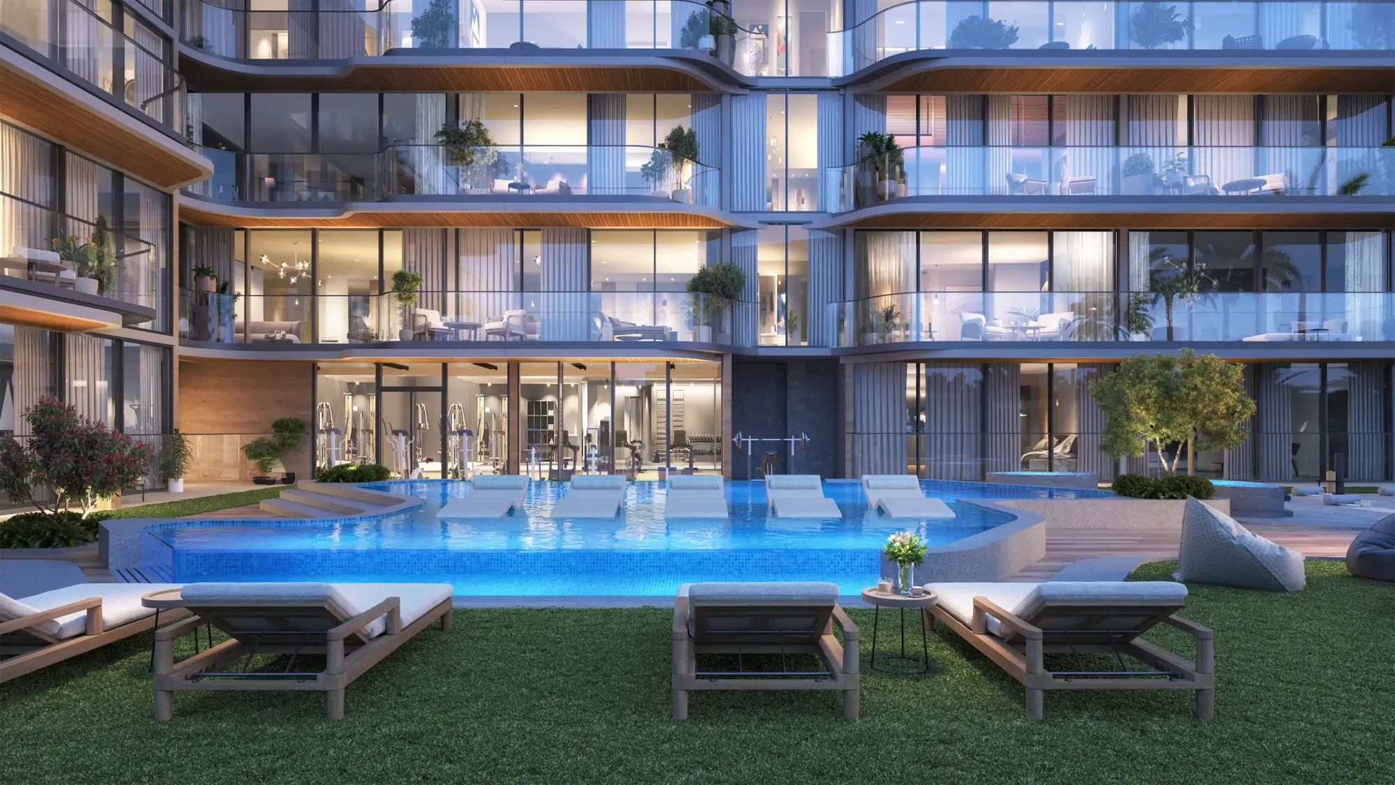 Luxurious apartment complex with a central blue-lit pool, glass balconies, and lounge seating outdoors at dusk/evening.