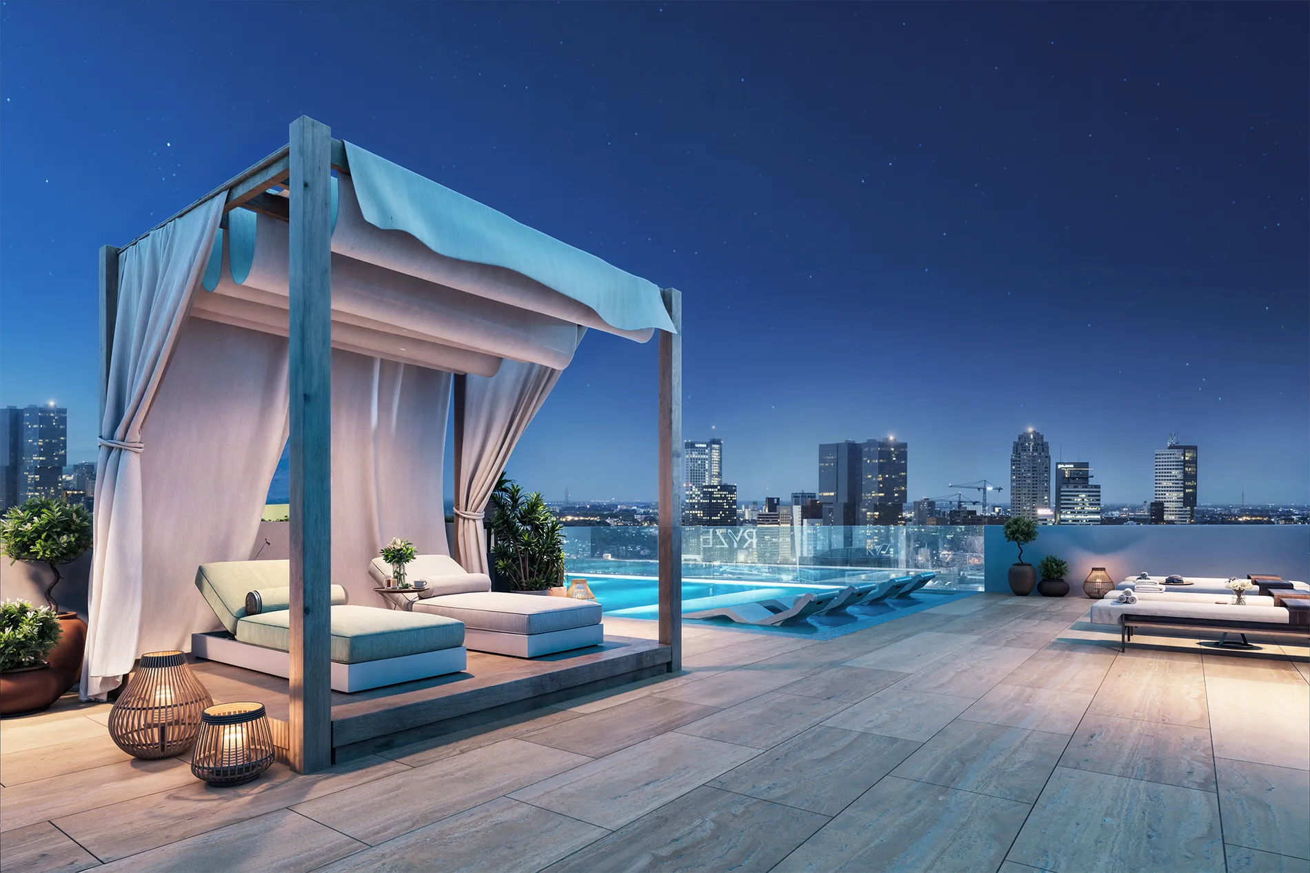Luxurious rooftop lounge at night with a draped cabana, pool, and distant city lights.