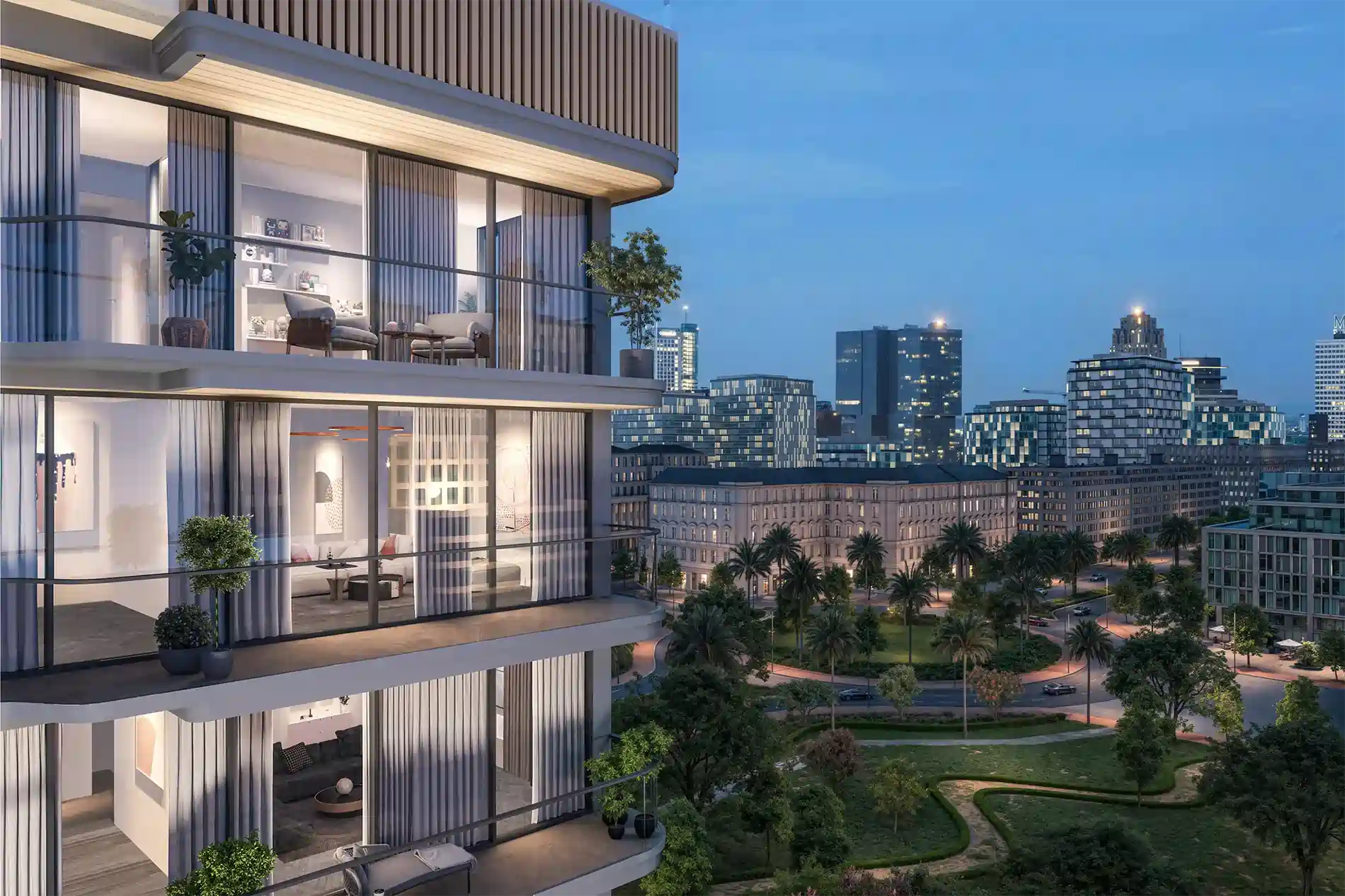 Modern glass condo building with spacious balconies overlooking a cityscape at dusk. Interior living spaces visible through floor-to-ceiling windows.