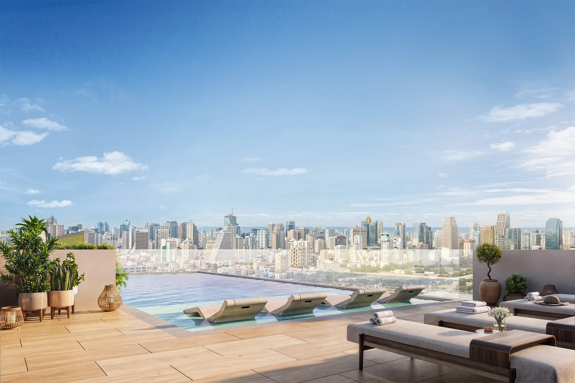 Rooftop pool deck with lounge chairs, potted plants, and a city skyline under a blue sky.